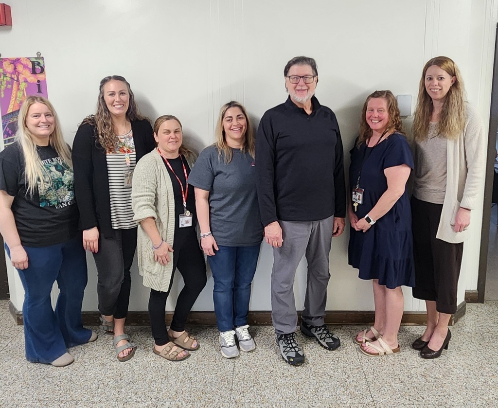 Seven adults smiling for a photo