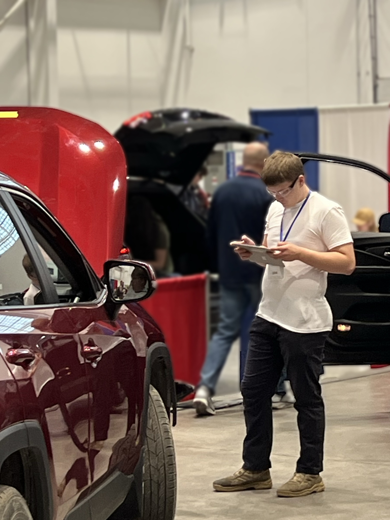 One student by a car.