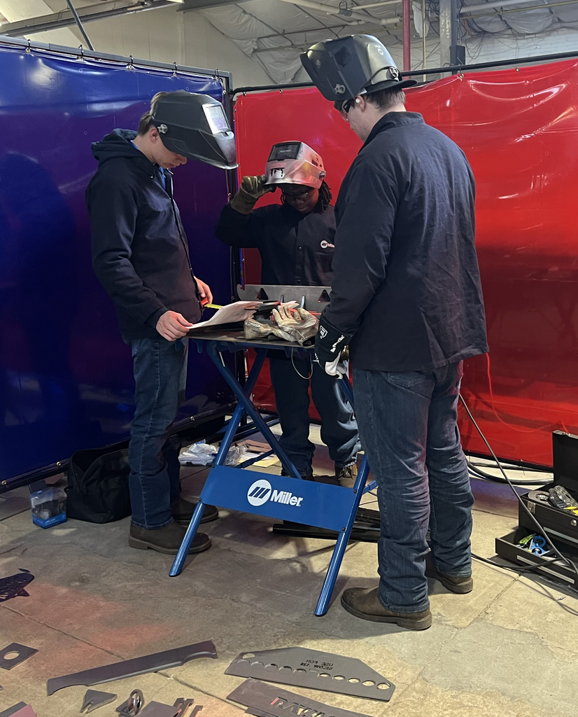 Three students with Welding equipment.