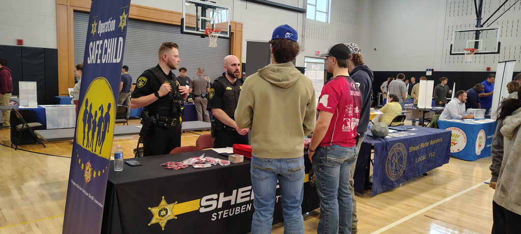 Group of students talking to representatives