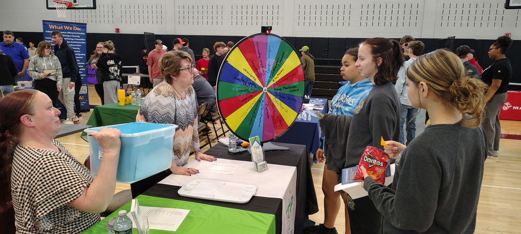 Students and business owner talking at a table