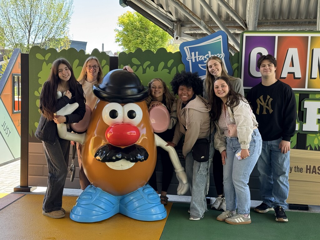 Students standing with Mr. Potato Head