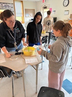 Students and a teacher working together