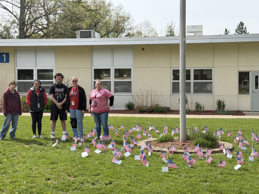 Group photo with flags in front of them