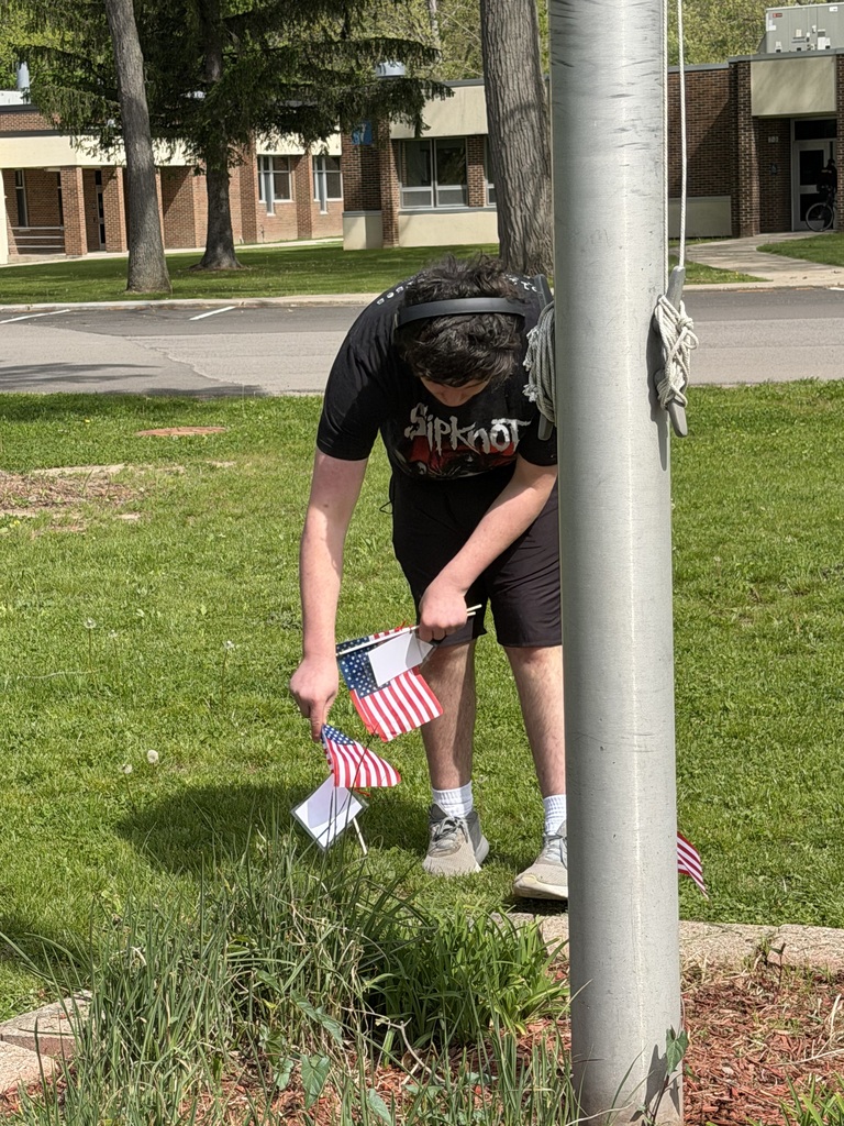 Student putting flags into the garden