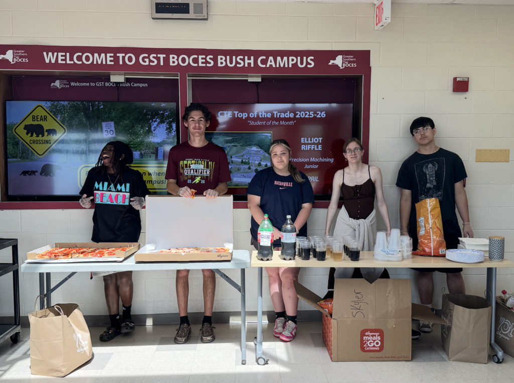 Students standing behind a table with food