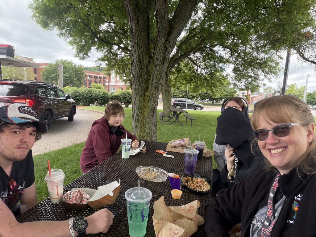 Staff and students at a picnic table smiling