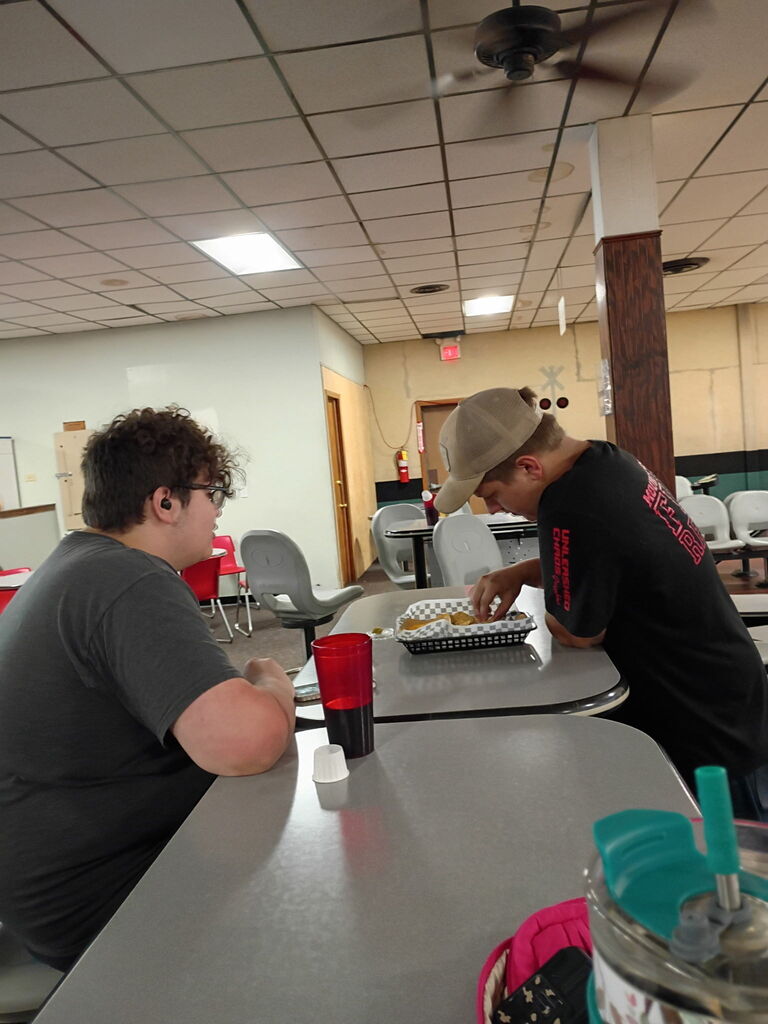 two students eating at a table