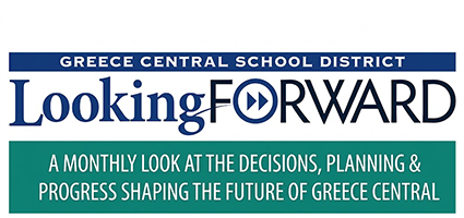 white sign with blue and green letters saying Looking Forward a monthly look at the decisions, planning & progress shaping the future of Greece Central