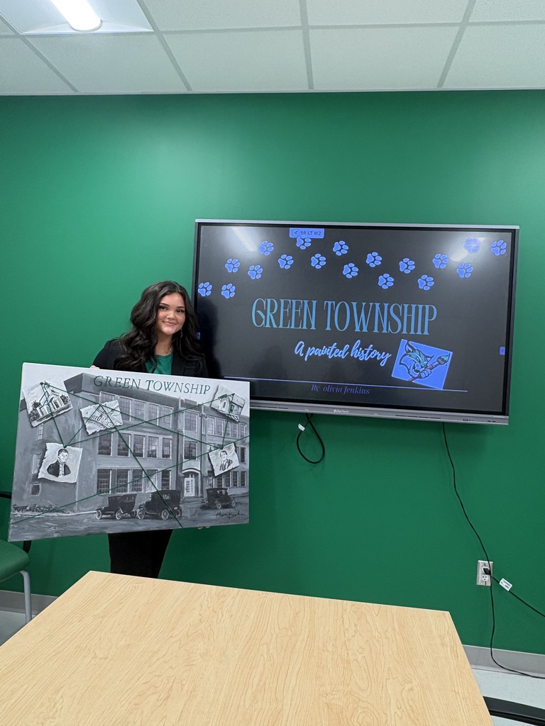 Liv Jenkins shows her senior project, Green Township, a Painted History.  She is holding a painting she created for the project.