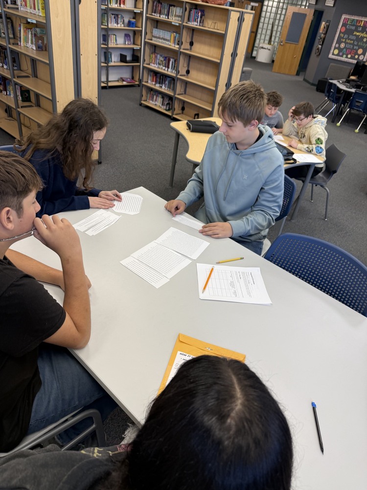 8th Grade students put together Argumentative Essays