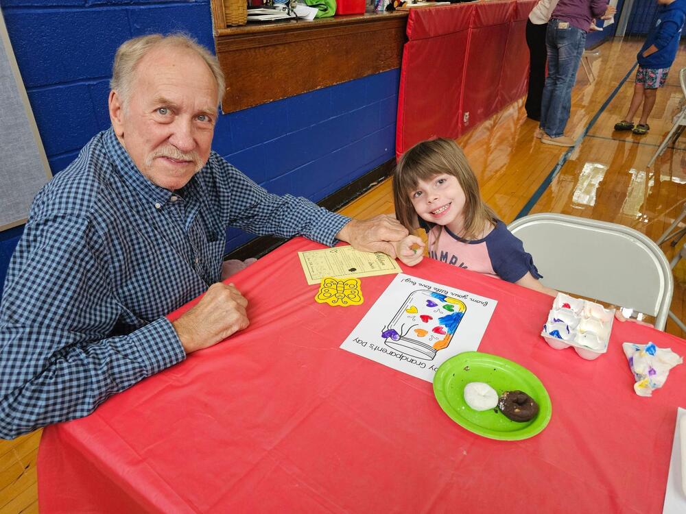 grandfather and granddaughter doing a craft
