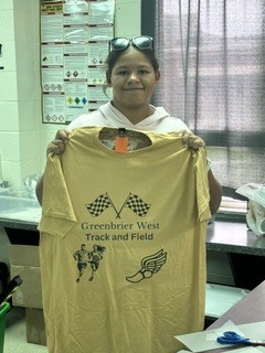 Student showing t-shirt about track and field