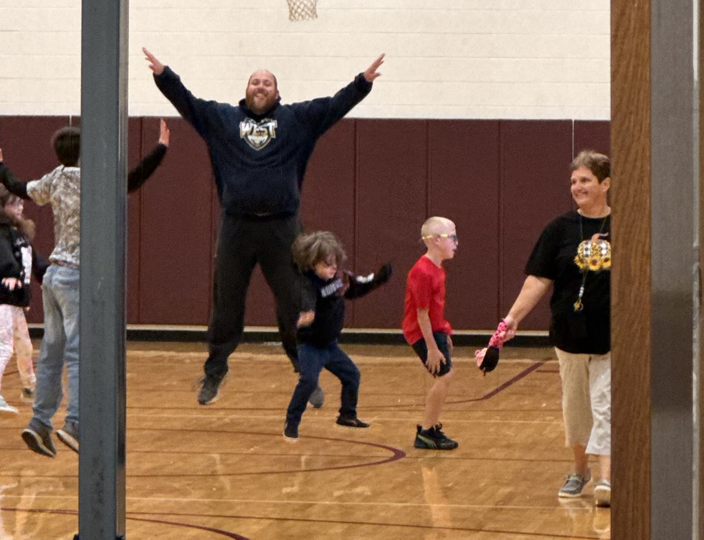 Coach Osborne leads students in morning exercises during bus hall.