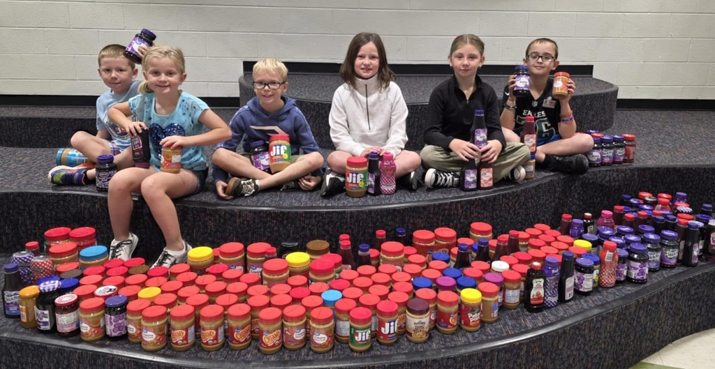 LES students pictured with their collection of peanut butter and jelly jars