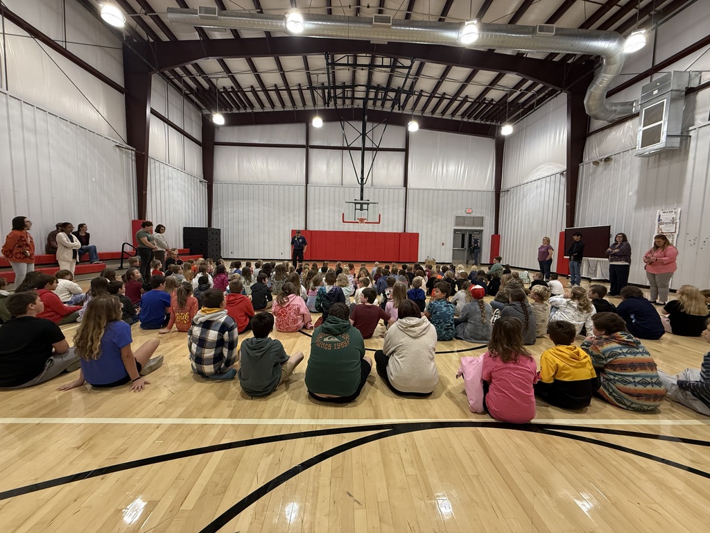 students sitting in a gym