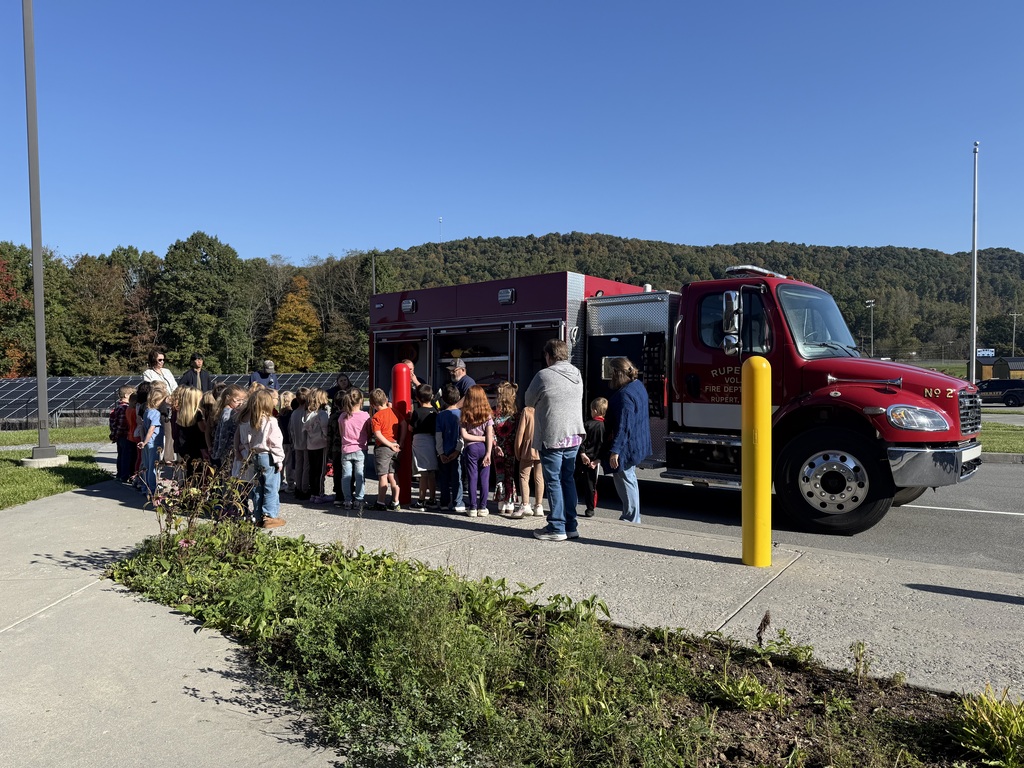 students looking at a fire truck