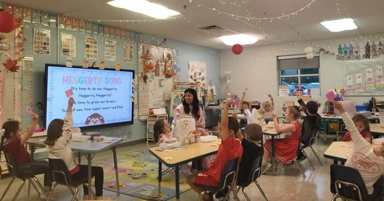 Students participating in an activity by raising their hands