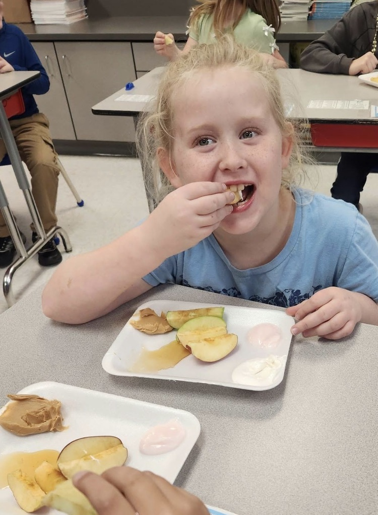 student biting apple