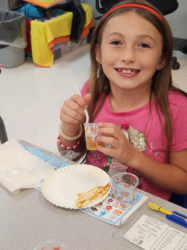student eating apple sauce 