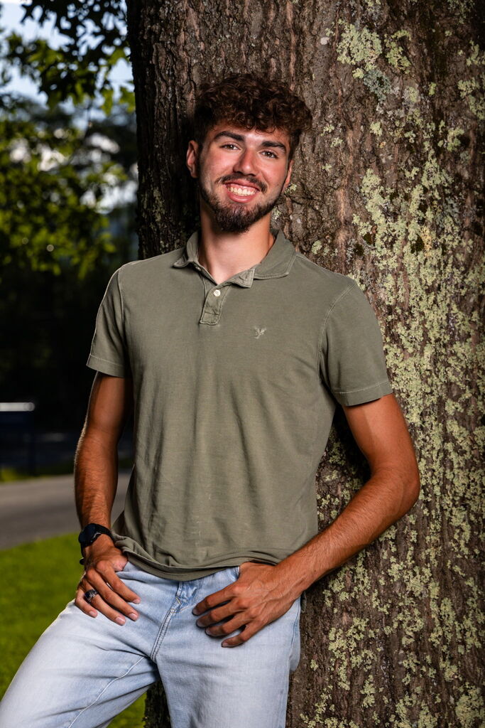 Picture of boy leaning on a tree