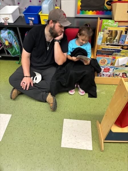Father reading to his preschooler
