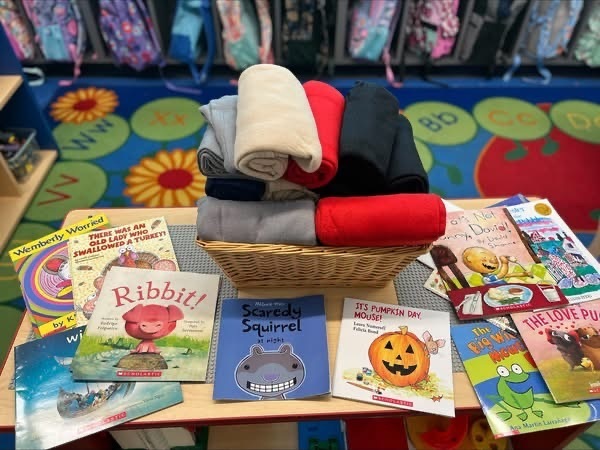 Basket of blankets and table full of books