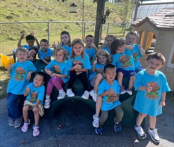 Class photo of preschoolers with new shirts on
