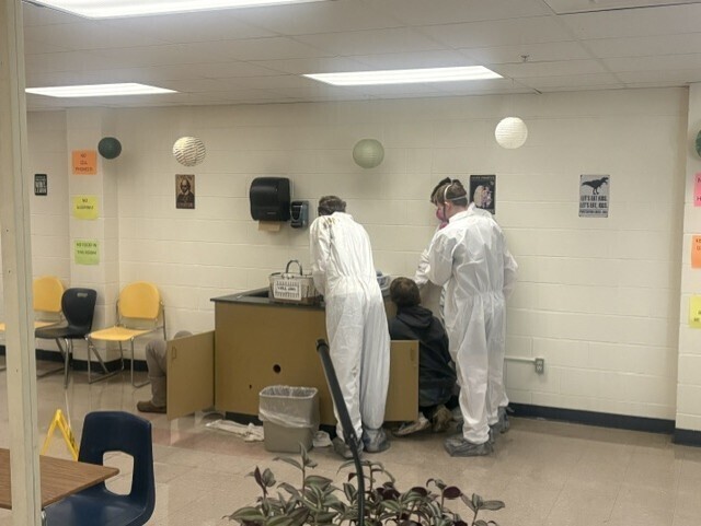 Students in hazmat suits