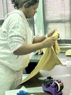 Student laying a shirt down