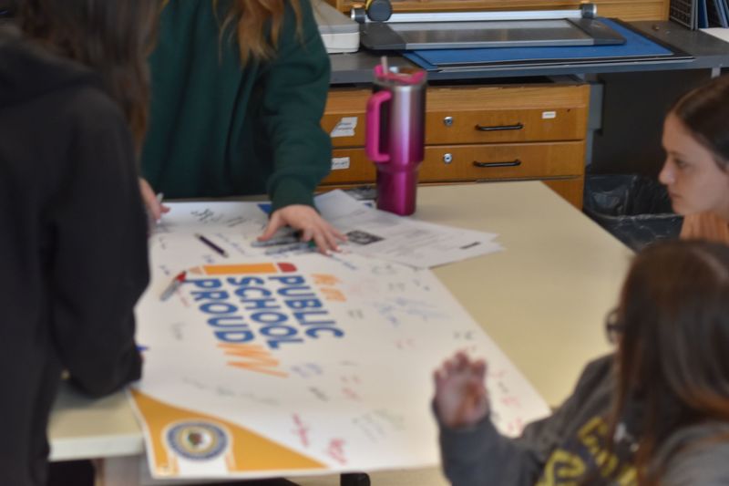 Students signing a banner