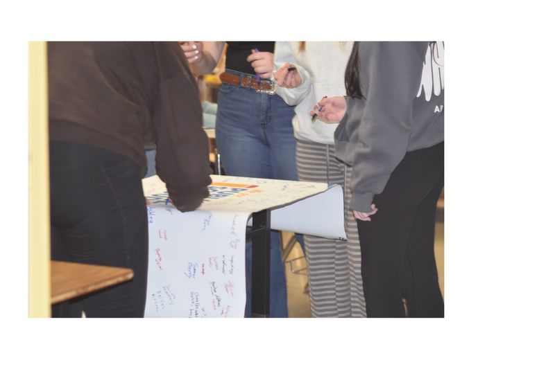 Students signing a banner