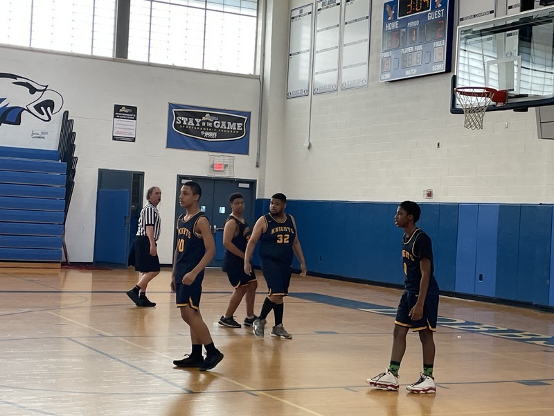 unified players play under the basketball hoop