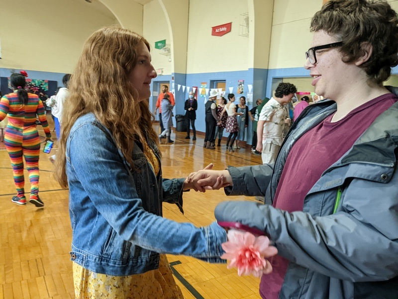 a clinician dances with a student