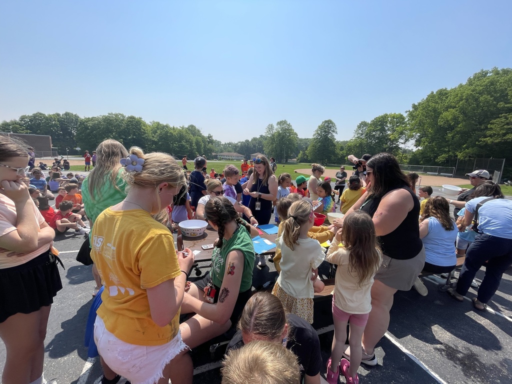Teachers getting temporary tattoos from students.