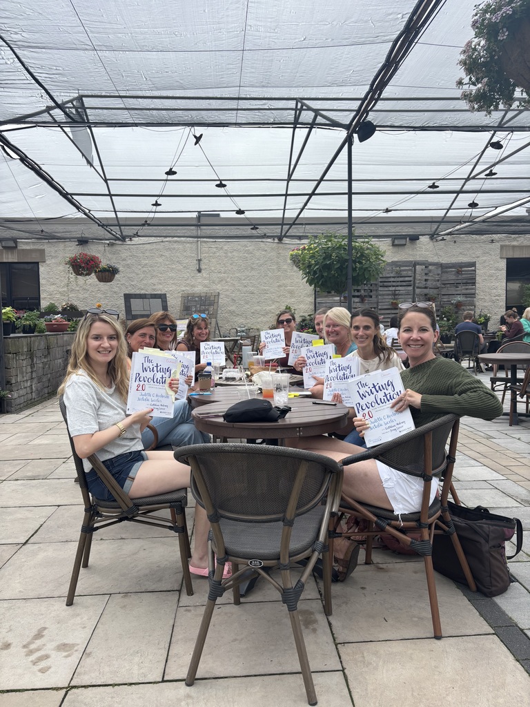 Teachers at a table reading a book together