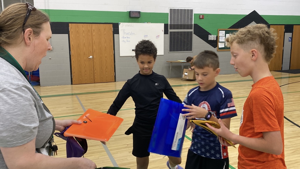 Kids collecting school supplies from teacher