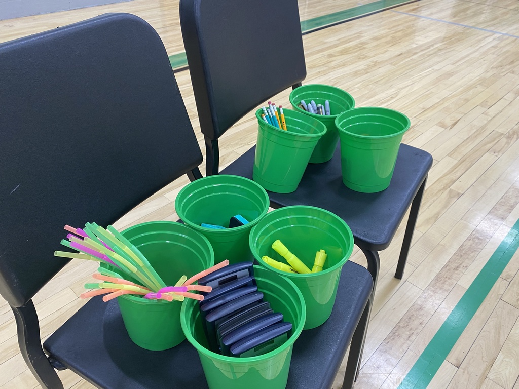 Green buckets with school supplies inside