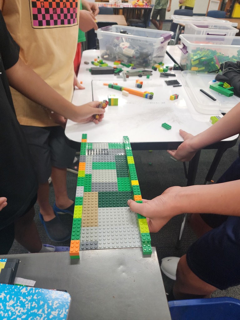 Hands making a Lego Bridge
