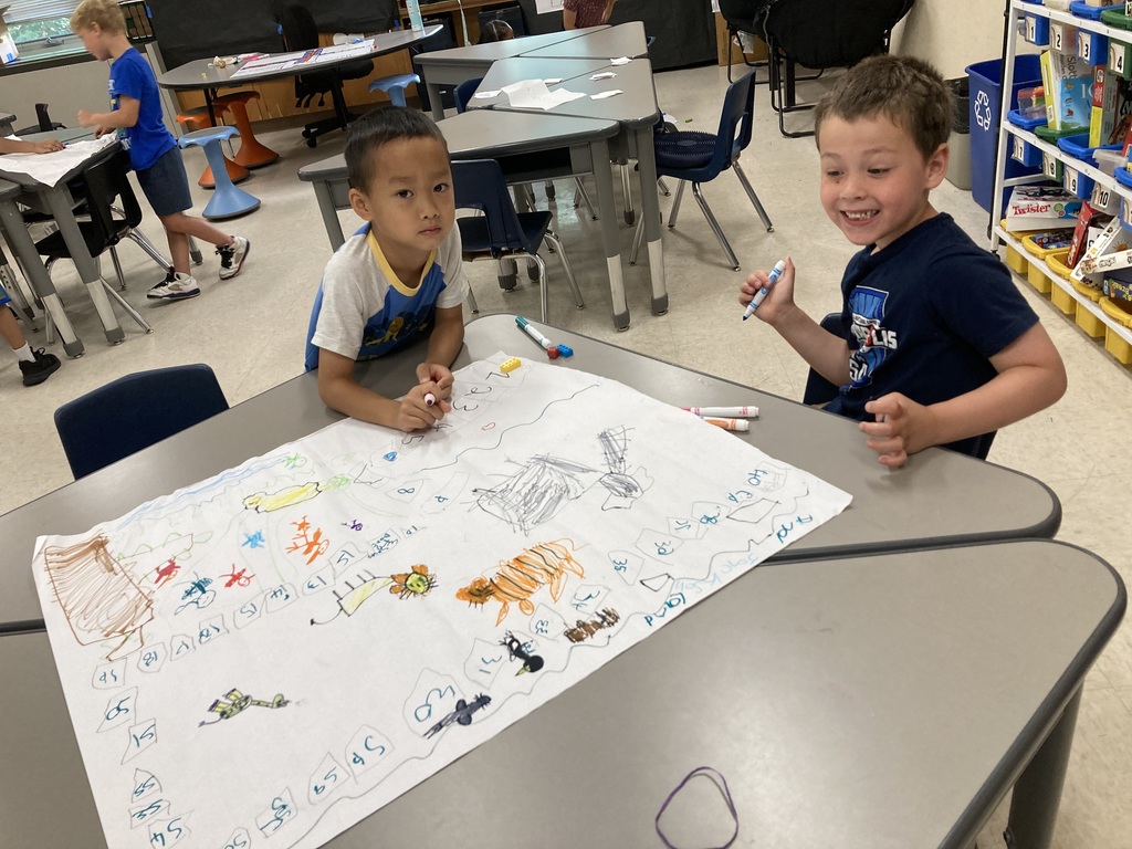 Two kids working on their zoo game