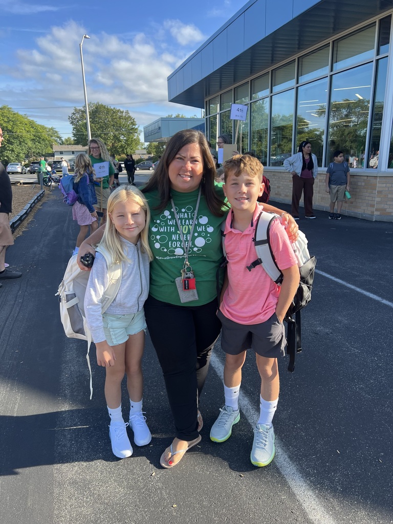 Principal with her children standing in front of school.