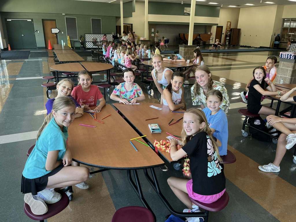Campers at a table working on activites