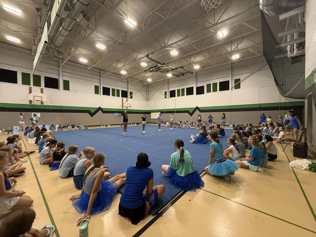 Campers seeing cheer skills demonstration