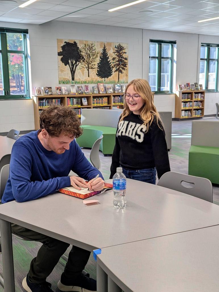 Struan Murray signing a book.