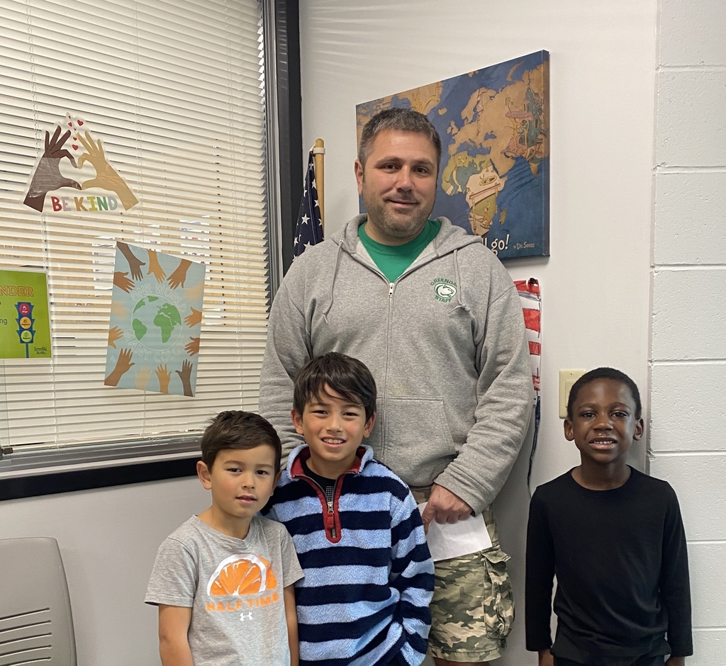 Three students smiling with Mr. Bob on their reward tour.