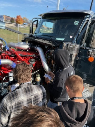 students looking at engine repair