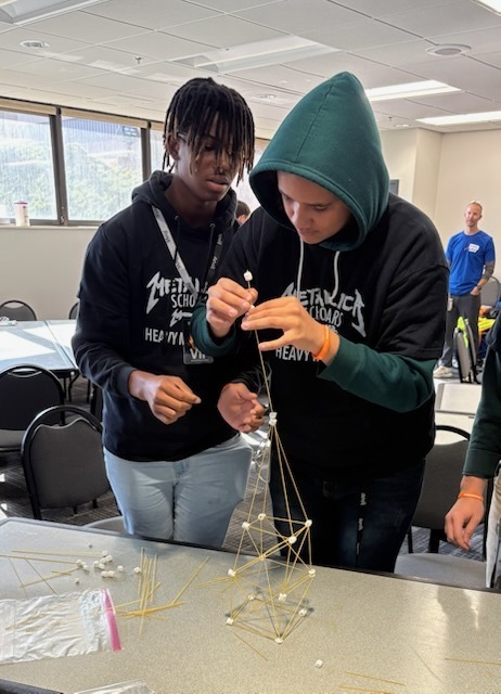 Students building the marshmallow and straw tower