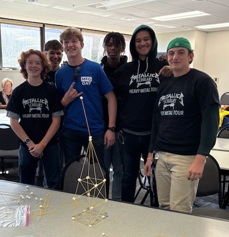Students building the marshmallow and straw tower