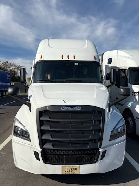Student in a semi truck cab.