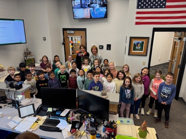 Students and school secretaries in the school office on gratitude day